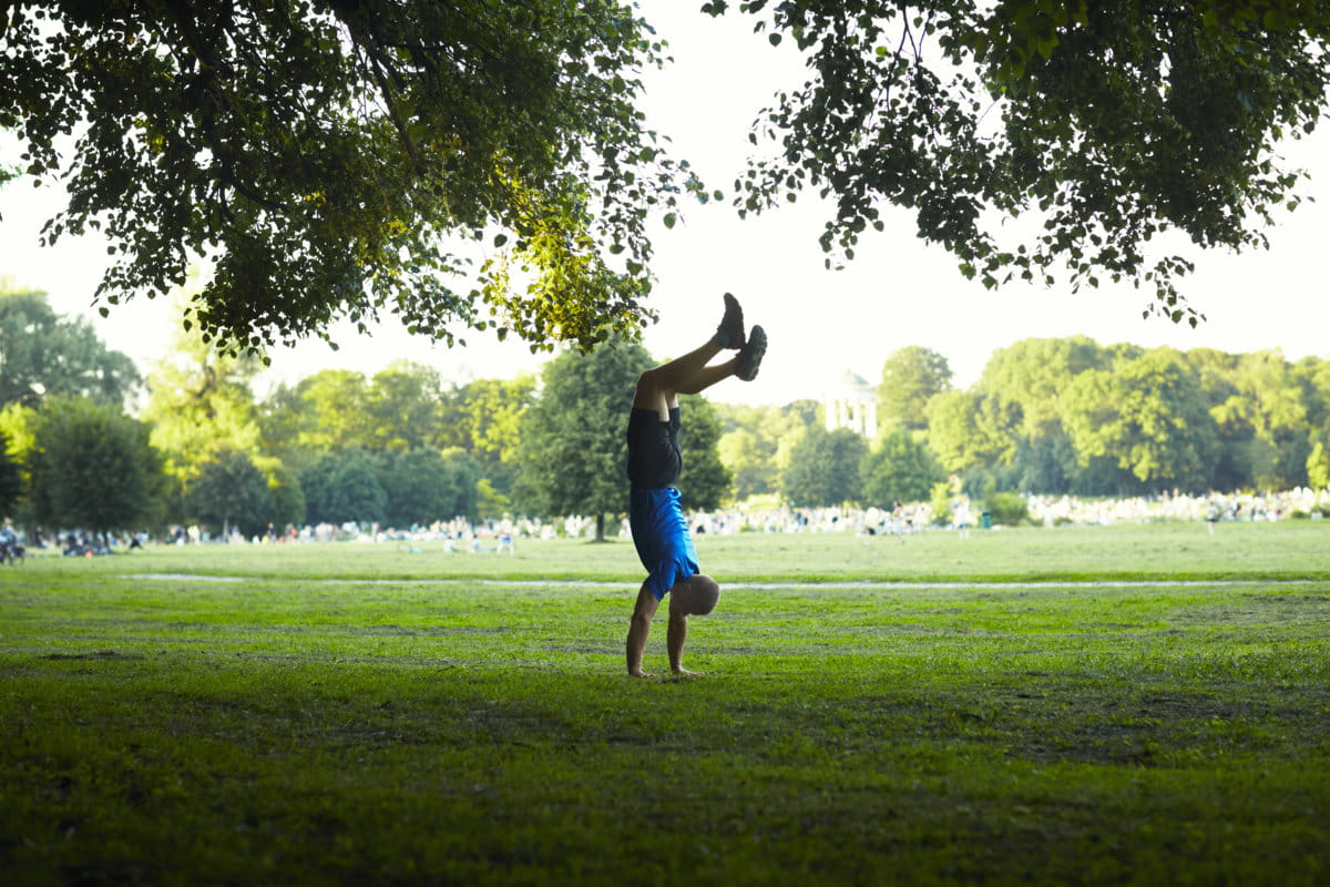 Mezczyzna w parku staje na rekach